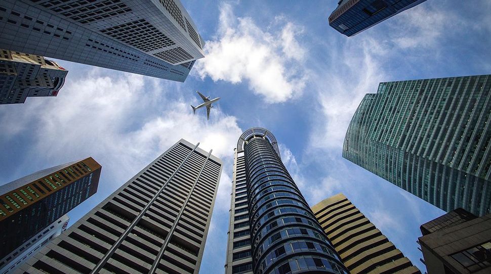 building | city | skyscrapers | plane | sky